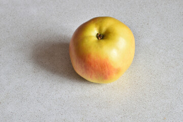 A beautiful, ripe apple lies on the table