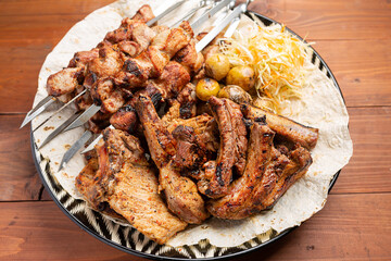 Roasted lamb ribs with sauce on wooden background,