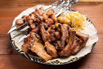 Roasted lamb ribs with sauce on wooden background,
