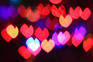 Bokeh background of colorful hearts at night