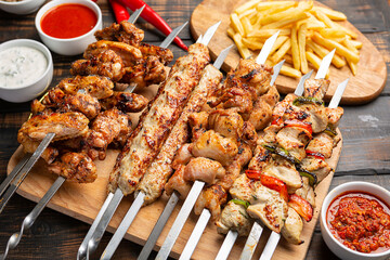 Assorted Mixed different grilled meat with vegetables on table