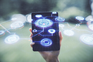 Double exposure of social network sketch hologram and woman holding and using a mobile device.