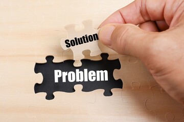 Missing puzzle with a message on Problem and a cropped hand holding a piece of puzzle with a text...