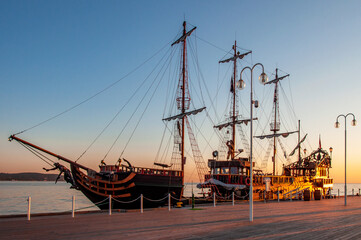 A touristic pirate ship at the piere (molo) in Sopot, Poland, in sunrise light