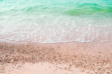 Sand beach with white sea soft wave on top view for assembling an article about travel in summer holiday or ocean coast nature.