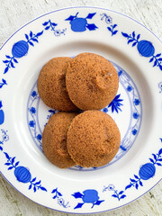 Putu Cangkir is a traditional snack from Makassar, South Sulawesi, Indonesia. Made from sticky rice, brown sugar, filled with grated coconut and covered with pandan leaves.