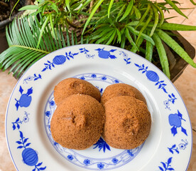 Putu Cangkir is a traditional snack from Makassar, South Sulawesi, Indonesia. Made from sticky rice, brown sugar, filled with grated coconut and covered with pandan leaves.