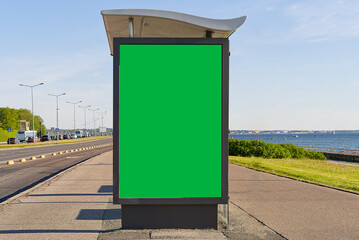 glass bus stop by the sea, with a chroma key advertising space. Blank billboard and outdoor...