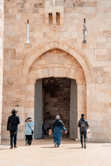 Fototapeta na wymiar Jaffa gate in Jerusalem. Jews and arabs go to the Old Town (46)