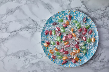 colorful candies in plate on a kitchen table