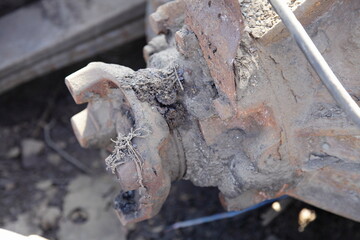 Old heavy truck cardan dirty cross joint mounting and reducer box on lorry rear axle close up, vehicle transmission repair service