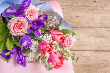 A beautiful bouquet of wedding flowers on old wooden boards