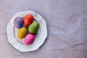 colored Easter eggs in a white plate