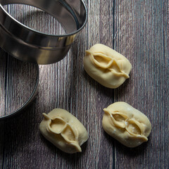 manti semi-finished products on the background of meat in the dough