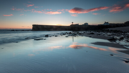 Sunrise on Seaton Sluice Beach and Harbour Mouth in the coast of Northumberland, England, UK.