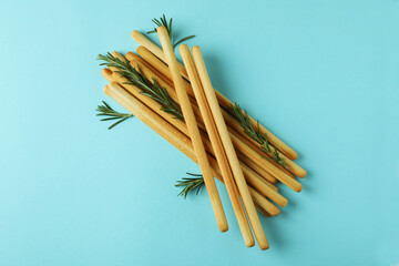 Grissini breadsticks with rosemary on blue background