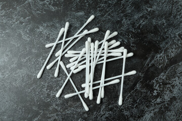 Cotton swabs on black smoky background, close up