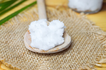 Unrefined coconut oil on a wooden spoon