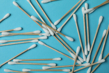 Cotton swabs on blue background, close up