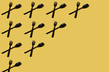repeated samples of cutlery on a yellow background - 424164108