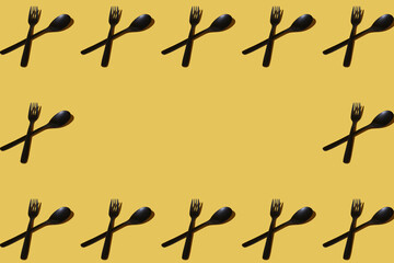 repeated samples of cutlery on a yellow background - 424164394