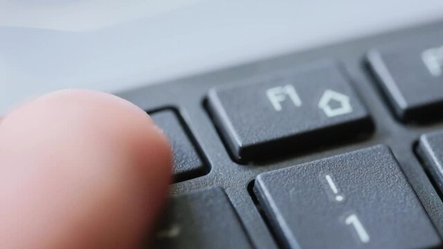 Man pressing esc button for multiple times