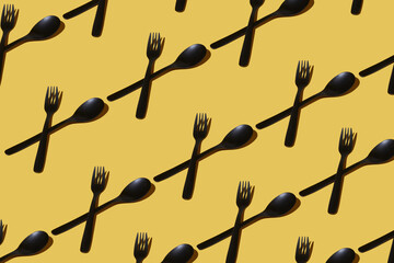 repeated samples of cutlery on a yellow background - 424164754