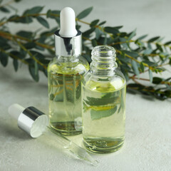 Concept of natural cosmetics with eucalyptus oil on white textured table