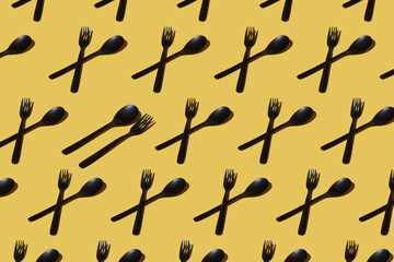 repeated samples of cutlery on a yellow background - 424164924