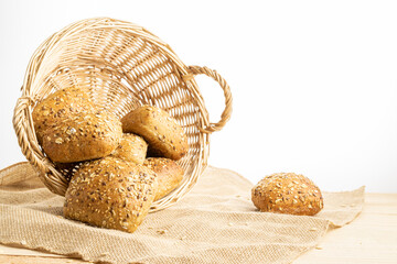 Traditional bread. Fresh loaf of rustic traditional bread with wheat grain ear or spike plant on linen texture background. Rye bakery with crusty loaves. Design element for bakery product label.