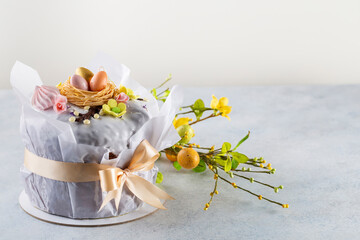 Spring Easter cake with white icing and sugar decor  and easter eggs on the  white table.  Easter concept