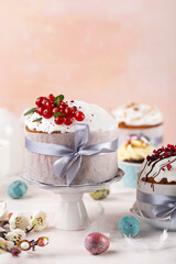Various Spring Easter cakes eggs with white icing and sugar decor  and easter eggs on the  white table.  Easter concept