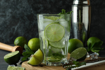 Glass of mojito cocktail and ingredients, close up