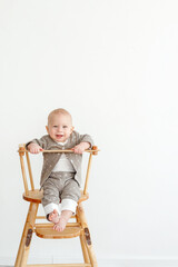 portrait of a baby on a chair on a light background