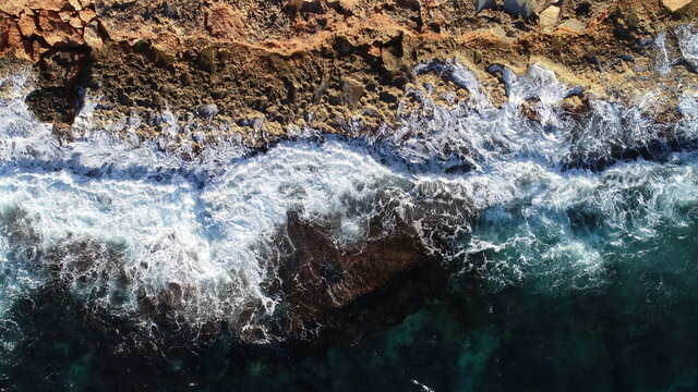 amazing top view of the hitting waves during the golden hour, textures and abstract. Mallorca