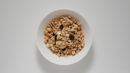 Heaps of muesli in white bowl, Top view