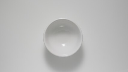 TOP VIEW: Empty small white dish on a table