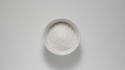 Obraz na płótnie Canvas Salt in white dish on a table, Top view