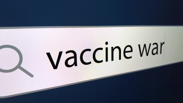 War vaccine at the end of a question mark written in a search bar with a cursor, a computer monitor, close-up with a camera zoom effect