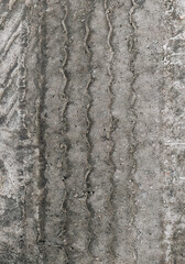 Textured traces, tread on muddy earth, sand, wet asphalt, road from a truck. Photography, concept.