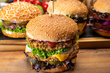Tasty vegetarian cheeseburgers and hamburgers with round patties or burgers made from grains, vegetables and legumes