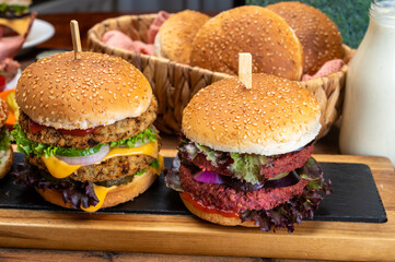 Tasty vegetarian cheeseburgers and hamburgers with round patties or burgers made from grains, vegetables and legumes