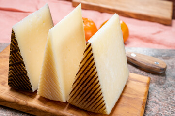 Cheese collection, pieces of hard Spanish manchego curado, viejo and iberico cheeses