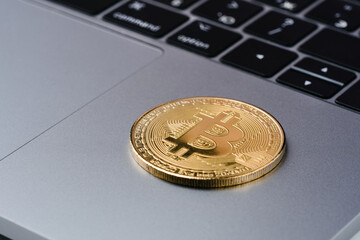 Bitcoin coin symbol on laptop, future concept financial currency, crypto currency sign. Close-up