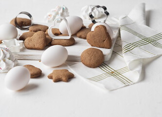 Homemade baking. Natural pastries for the Easter holiday honey cookies with white eggs on a light background.