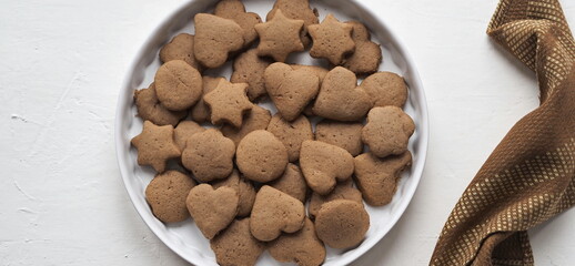 Creamy honey cookies with cocoa in a white dish. Homemade natural pastries for a holiday or every day.