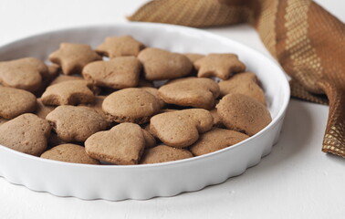 Creamy honey cookies with cocoa in a white dish. Homemade natural pastries for a holiday or every day.