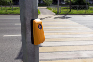 Button on a pedestrian crossing over a highway in the city.