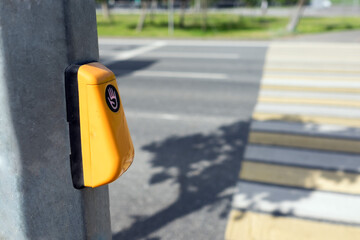 Button on a pedestrian crossing over a highway in the city.