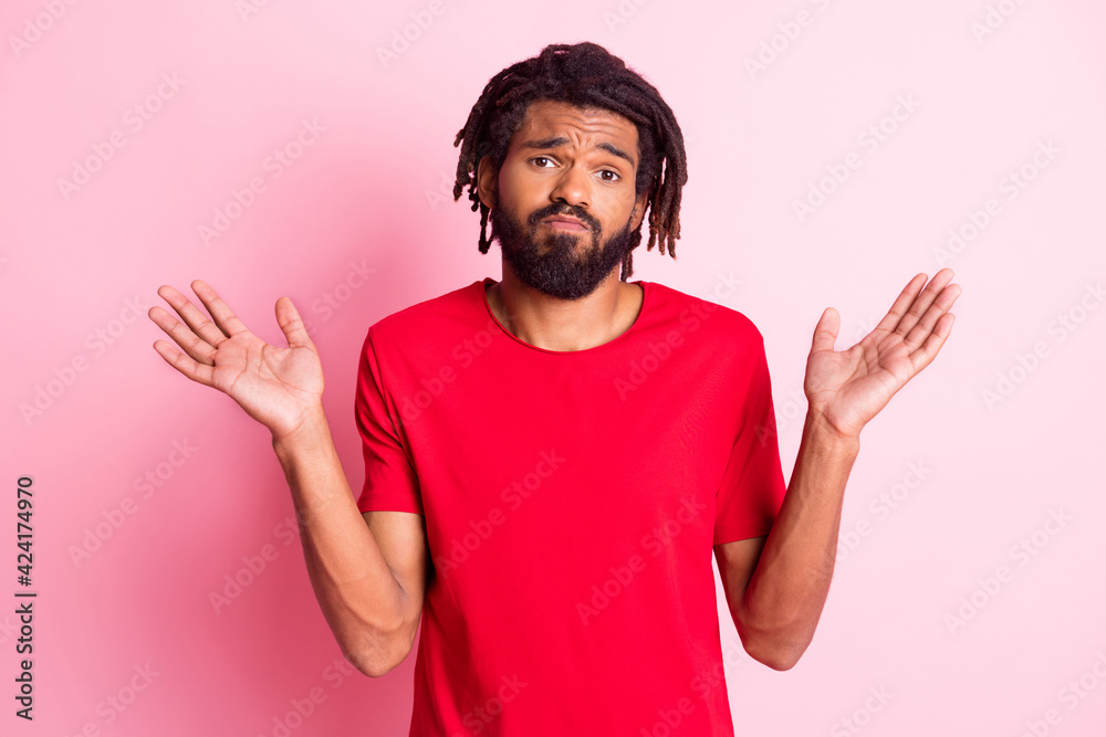 Wall mural photo of young african woman unhappy upset shrug shoulders no answer clueless confused isolated over